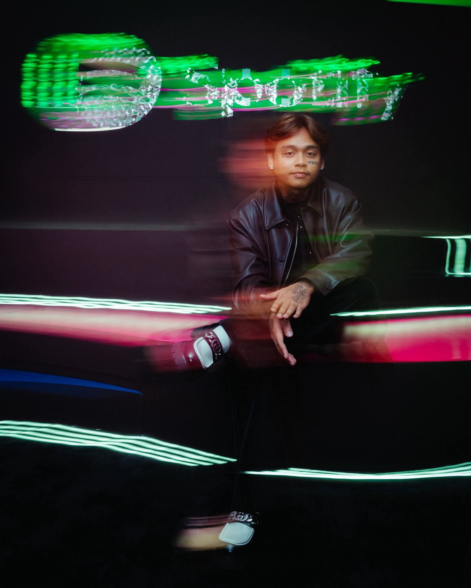 Artist seated neon